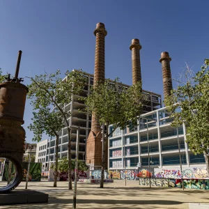 Estos jardines de aspecto netamente urbano están ubicados en los terrenos ocupados antiguamente por la central eléctrica de Barcelona Traction, Light and Power Company, limited —conocida popularmente como La Canadiense—, una de las pioneras en la ciudad condal. De la antigua central solo subsisten las chimeneas (fechadas en 1897, 1908 y 1917), rodeadas hoy día por un edificio de oficinas de FECSA, que ocupa una cuarta parte del terreno, estando el resto dedicado al parque. Jardines de las tres chimeneas, creados en 1995 con un diseño de Pere Riera y Josep Maria Gutiérrez